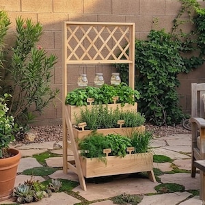 May include: A three-tiered wooden planter stand with a lattice top and three hanging glass jars. The planter features rectangular wooden boxes filled with various green herbs, each labelled with small wooden signs reading Basil, Rosemary, Thyme, Dill, and Chives.