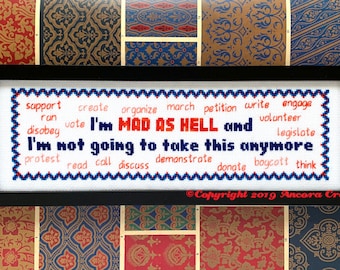 May include: White cross-stitch embroidery with a red and blue border. The text reads "I'm MAD AS HELL and I'm not going to take this anymore."  The text is surrounded by a list of action verbs in blue and red.