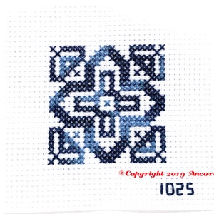 ThreadworX 1025 Variegated Embroidery Floss Blue Navy thread has a repeating gradient of medium to dark navy blues and is shown here stitched in a geometric cross stitch pattern.