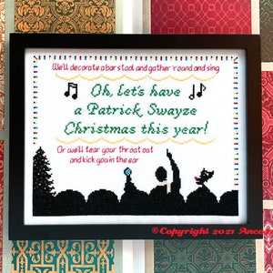 May include: A framed cross-stitch design with a white background and black text that reads "We'll decorate a bar stool and gather 'round and sing Oh, let's have a Patrick Swayze Christmas this year! Or we'll tear your throat out and kick you in the ear." The design features a black silhouette of a Christmas tree and people singing in front of a stage. The bottom right corner of the frame has the text "Copyright 2021 Anco".