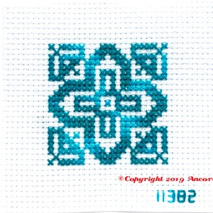 ThreadworX 11382 Variegated Embroidery Floss Blue Swirl thread has a repeating gradient of gorgeous deep water blues and is shown here stitched in a geometric cross stitch pattern.