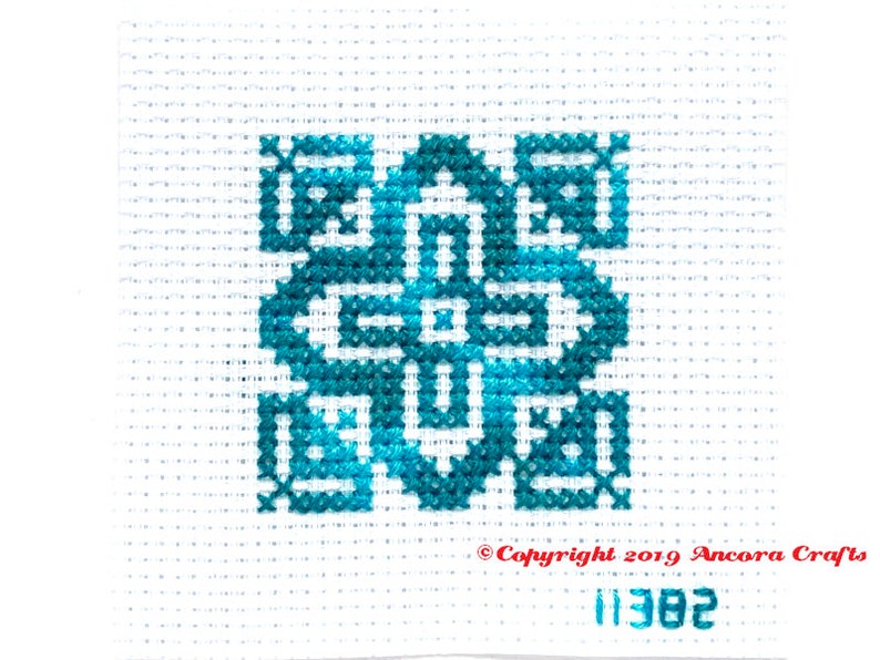 ThreadworX 11382 Variegated Embroidery Floss Blue Swirl thread has a repeating gradient of gorgeous deep water blues and is shown here stitched in a geometric cross stitch pattern.