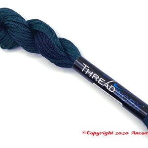 May include: A skein of dark green embroidery floss with the text "THREADWORX" on the label.