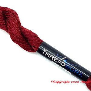 May include: A spool of deep red embroidery floss with a black label that reads "THREADWORK" and "Copyright 2020 Ancora Crafts".