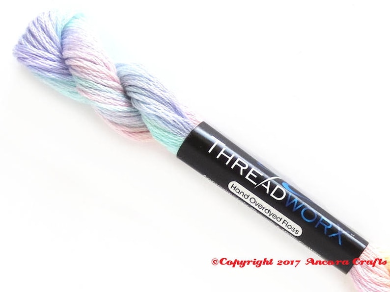 ThreadworX 10592 Variegated Rainbow Embroidery Floss Wildflowers thread has a gradient of pastel pink, orange, yellow, green, blue, and purple and is used for cross stitch, embroidery, needlepoint, making friendship bracelets, and other crafts.