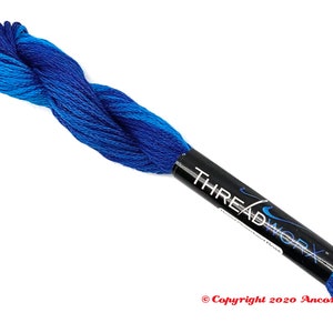 May include: A skein of blue embroidery floss with a white label that reads "THREADWORK" in a black and white swirl design.
