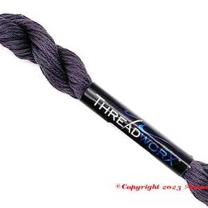 May include: A skein of dark purple embroidery floss with the brand name "THREADWORX" printed on the label.