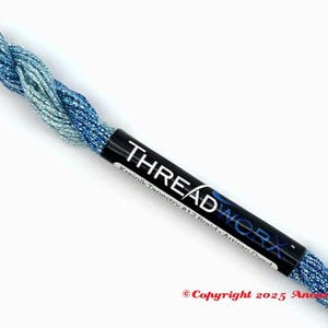 May include: A spool of blue and silver metallic thread. The label reads "THREADWORX" in white text on a black background. The thread is labeled "Kreink Tapestry #12 Braid - Artisan Dyed."
