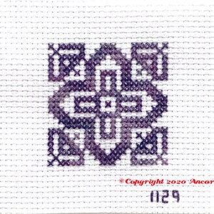 ThreadworX 1129 Variegated Embroidery Floss Merlot thread has a repeating gradient of dusky medium and dark purples and is shown here stitched in a geometric cross stitch pattern.