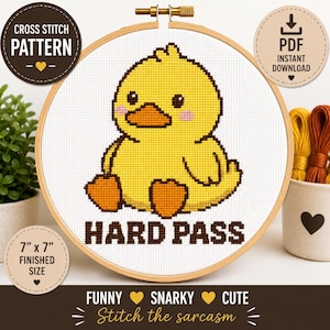 May include: A cross stitch pattern in a wooden hoop featuring a yellow duck with orange feet and beak, pink cheeks, and the text HARD PASS in brown. The design is on white fabric, with a 7 inch by 7 inch finished size label and PDF download icon.