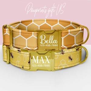 May include: Two personalized dog collars with gold-colored hardware. The top collar has a honeycomb pattern and the name "Bella" printed on the buckle. The bottom collar has a bee and honeycomb pattern with the name "MAX" printed on the buckle. The collars have a phone number printed on them.
