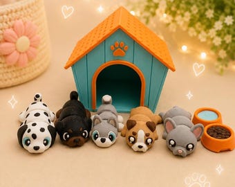 May include: A set of five small dog figurines in front of a teal and orange plastic dog house. The dogs include a dalmatian, a black dog, a grey husky, a brown and white dog, and a grey bulldog, accompanied by two small orange feeding bowls.