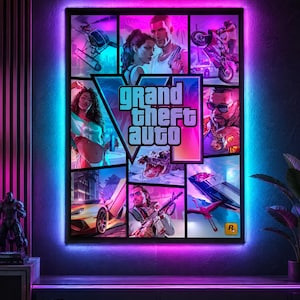 May include: A rectangular wall art piece featuring a collage of Grand Theft Auto VI game imagery, including characters, a sports car, a helicopter, and a crocodile, illuminated by a vibrant pink and blue LED backlight frame on a dark wall.