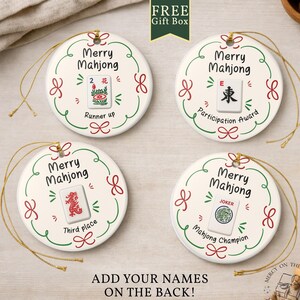 May include: Four round white ceramic ornaments with gold hanging strings. Each features a green and red wreath design, the text Merry Mahjong, and a unique mahjong tile graphic with labels: Runner up, Participation Award, Third place, and Mahjong Champion.