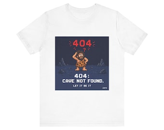May include: White t-shirt with a pixelated graphic. The graphic shows a caveman with the text "404: CAVE NOT FOUND. LET IT BE IT". The caveman is in front of a pixelated background with the number "404" above his head.