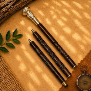 May include: A three-piece walking stick featuring a polished silver-toned handle with intricate embossed detailing. The dark brown wooden shaft is segmented into three parts, each displaying carved floral patterns and threaded metal connectors.