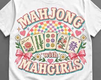 Puede incluir: Una camiseta blanca de manga corta con un gráfico colorido y el texto "MAHJONG with MAHGIRLS". El diseño incluye cinco fichas de mahjong, un arcoíris a cuadros, lazos rosas, margaritas y corazones pequeños en una ilustración detallada.