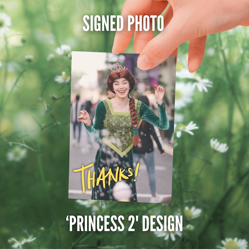 May include: A rectangular signed photo featuring a person dressed as a princess with a long braided auburn hairstyle, a small crown, and a green velvet dress with a gold bodice. The word THANKS is printed in yellow script at the bottom of the image.