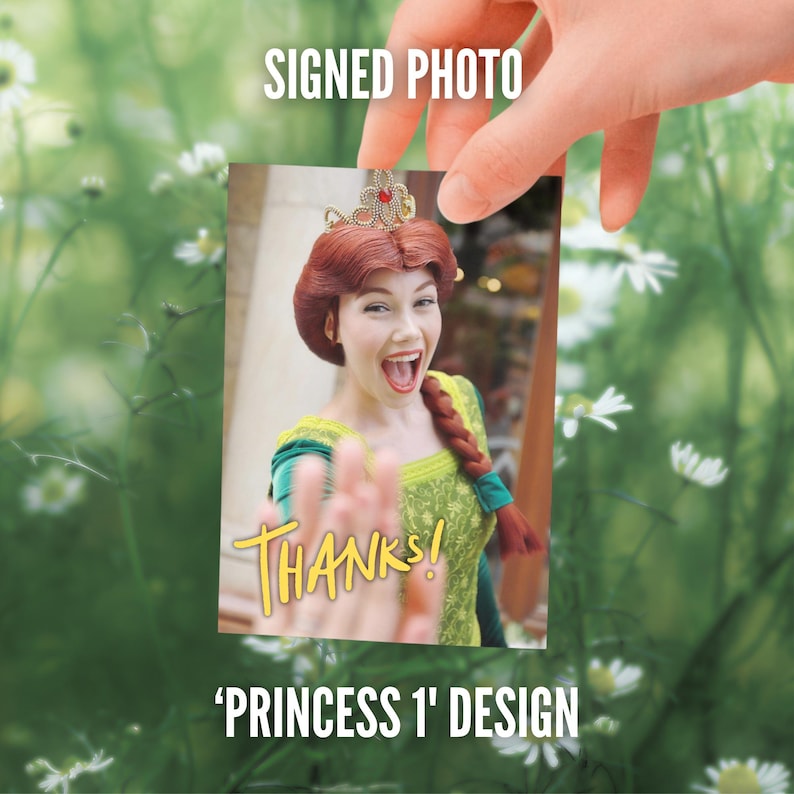 May include: A rectangular photograph featuring a person dressed as a princess with auburn hair in a braid, a gold crown, and a green dress. The image includes the yellow text THANKS! and is labeled as SIGNED PHOTO and PRINCESS 1 DESIGN.