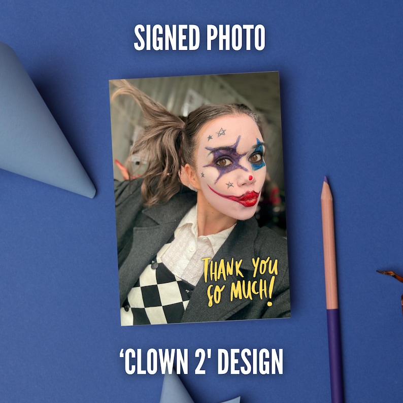 May include: A rectangular signed photo featuring a person with clown makeup, including a red nose, dark eye markings, and small stars on the forehead. The person wears a white collared shirt, a black and white checkered vest, and a dark gray blazer. The text reads THANK YOU SO MUCH.
