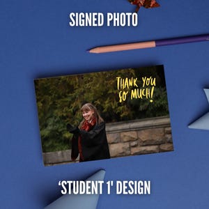May include: A rectangular signed photo featuring a student in a black robe with a red scarf, standing before a stone wall and trees. The text 'THANK YOU SO MUCH!' is printed in yellow script. The photo is labeled 'STUDENT 1' DESIGN.