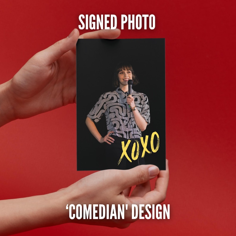 May include: A rectangular photograph featuring a person with short dark hair wearing a short-sleeved shirt with a white and black abstract pattern. The person holds a microphone. The word XOXO is written in yellow script at the bottom right.