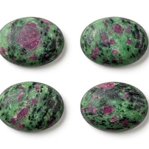 May include: Six oval-shaped cabochons of ruby zoisite, each featuring a polished surface with a mottled pattern of vibrant magenta-pink ruby inclusions embedded within a matrix of deep forest green zoisite and dark black hornblende mineral.