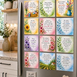 May include: A set of twelve square magnets featuring watercolor floral illustrations and Bible verses from Proverbs 31, plus one rectangular magnet with the text Be still and know and one heart-shaped magnet, all displayed on a stainless steel refrigerator.