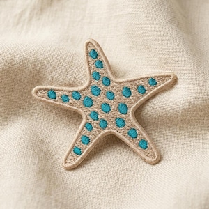 May include: A five-pointed starfish patch featuring tan embroidery thread as the base color and vibrant teal circular spots embroidered across the surface. The edges of the starfish are finished with a dense, raised tan stitched border.