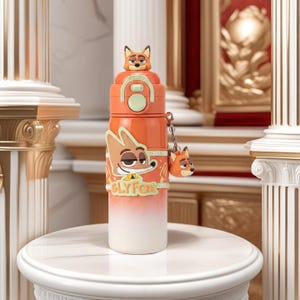 May include: An orange and white insulated water bottle featuring a cartoon fox design. The bottle has a fox-shaped lid and a matching keychain. The words "SLY FOX" are printed on the bottle.