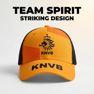 May include: Orange and black baseball cap with the text "TEAM SPIRIT STRIKING DESIGN". The cap features a black lion emblem and the letters "KNVB" in black. The back of the cap is black mesh.