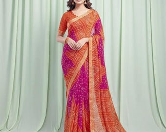 May include: A vibrant saree in shades of orange and fuchsia. The fabric features a detailed pattern with a gold border. The saree is draped on a person, showcasing the design and color combination. The sleeves of the blouse are short and orange.