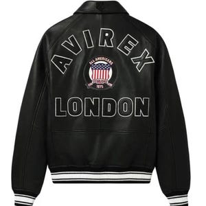 May include: Black leather jacket with white lettering that reads "AVIREX LONDON" on the back. The jacket has a patch with the American flag and the words "ALL AMERICANS ESTABLISHED 1975". The jacket has white and black striped cuffs.