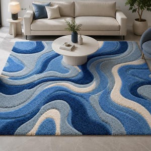 May include: A rectangular area rug featuring a high-pile texture with a flowing, abstract wave pattern in various shades of deep blue, light blue, and cream. The design consists of layered, curved bands that create a sense of depth and movement.