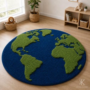 May include: A circular area rug featuring a textured map of the world with deep blue oceans and vibrant green landmasses. The rug has a thick, tufted pile construction and displays the continents of North America, South America, and Africa.