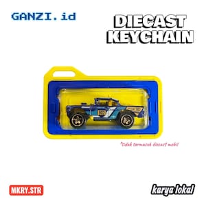 May include: A diecast keychain featuring a blue and white toy truck with the number 902. The truck is displayed in a yellow and blue case. The text "DIECAST KEYCHAIN" is above the case.