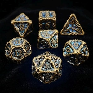 May include: Set of seven antique brass-colored polyhedral dice with blue accents. Each die features intricate designs and clearly visible numbers. Ideal for tabletop gaming, these dice are a unique addition to any collection.