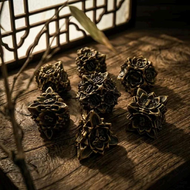 May include: A collection of antique brass dice with floral designs and numerical markings. The dice are arranged on a wooden surface, with a warm, inviting color palette. The dice are a unique item for board game enthusiasts.