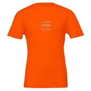May include: A bright orange short-sleeved t-shirt featuring the text "CODE NINJA" in white capital letters, followed by a horizontal line and the smaller white text "cloud life" centred on the chest area of the garment.