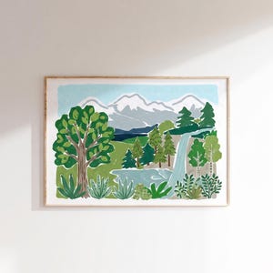 May include: A framed landscape art print featuring a stylized mountain range with snow-capped peaks, a cascading waterfall, a central lake, and various green trees and shrubs in the foreground, all rendered in a flat, graphic illustration style.