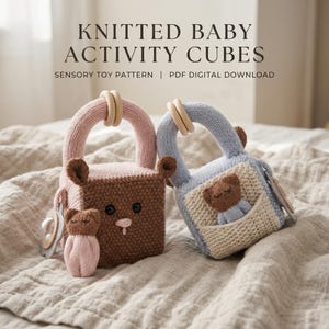 May include: Two knitted baby activity cubes with handles and wooden rings. One cube is brown with a small pink bear, the other is light blue with a small brown bear in a pocket. Text reads: KNITTED BABY ACTIVITY CUBES SENSORY TOY PATTERN | PDF DIGITAL DOWNLOAD.