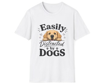 May include: White t-shirt featuring a graphic of a golden retriever dog with the text "Easily Distracted by Dogs". The dog graphic is in the center of the shirt, with the text below it. The shirt is a classic crew neck.