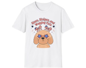 May include: White t-shirt featuring a cartoon dog with star-shaped sunglasses and bow ties in red, white, and blue. The text "Stars, Stripes, and Wagging Tails" is above the dog.