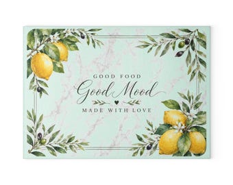 May include: Rectangular cutting board with a light green marble background. The board features a decorative border of olive branches and lemons. Text reads "Good Food, Good Mood, Made with Love."