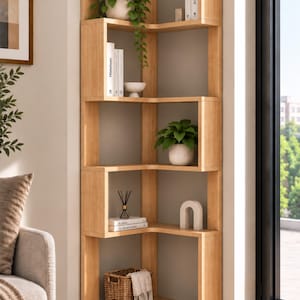 May include: A light wood corner bookshelf featuring five open tiers with a geometric design. The shelves hold various items including potted green plants, white books, a small white bowl, a decorative arch object, and a woven basket with a white cloth.