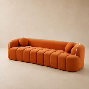 May include: A burnt orange sofa featuring a channel-tufted seat and backrest design. The piece includes rounded armrests, a white piped trim along the top edges, and two matching circular throw pillows positioned at each end of the seating area.