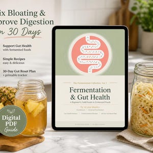 May include: A tablet displaying a digital guide on fermentation and gut health. The image features a jar of sauerkraut, a jar of pineapple drink, and text that reads "Fix Bloating & Improve Digestion in 30 Days."