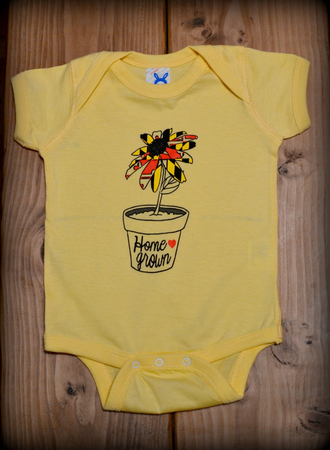 Light yellow Home Grown baby onesie featuring Etsy