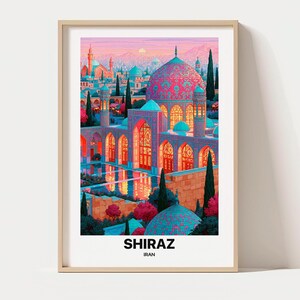 May include: A framed art print featuring a vibrant illustration of a mosque in Shiraz, Iran, with intricate pink and blue domes, arched doorways, and a reflecting pool. The text SHIRAZ IRAN is printed in bold black letters at the bottom of the print.