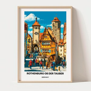 以下が含まれることがあります： ドイツのローテンブルク・オプ・デア・タウバーを描いた鮮やかなイラストの額入りトラベルポスター。歴史的な木組みの建物、石造りの時計塔、青い空の下、石畳の通りを歩く人々が描かれています。下部には「ROTHENBURG OB DER TAUBER GERMANY」の文字があります。